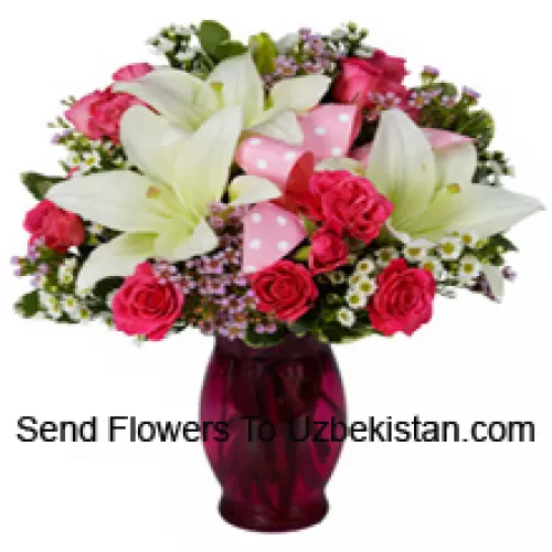 Pink Roses And White Lilies With Seasonal Fillers In A Glass Vase