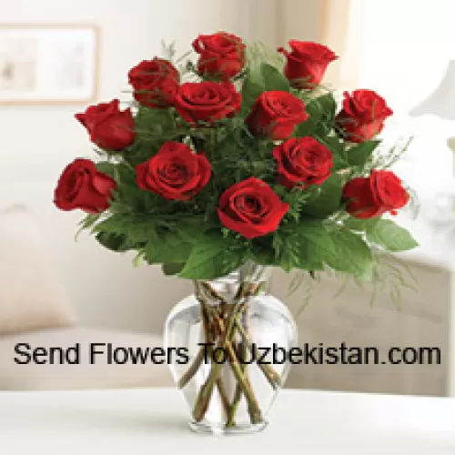 11 Red Roses With Some Ferns In A Glass Vase