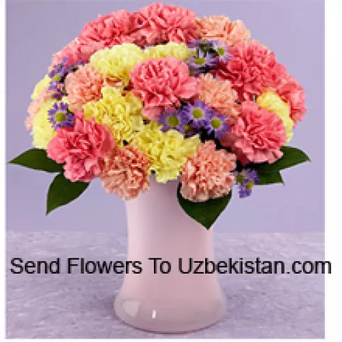 25 Mixed Colored Carnations With Seasonal Fillers In A Glass Vase