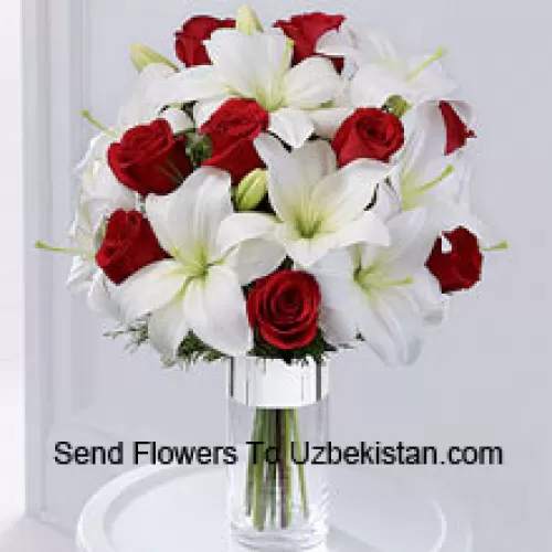 This product is a sleek and elegant way to spread goodwill for the holiday season. Red roses are set to catch the eye arranged amongst white Oriental lilies in a clear glass cylinder vase wrapped in silver ribbon to create a seasonal display of heartfelt wishes for a magical holiday. (Please Note That We Reserve The Right To Substitute Any Product With A Suitable Product Of Equal Value In Case Of Non-Availability Of A Certain Product)