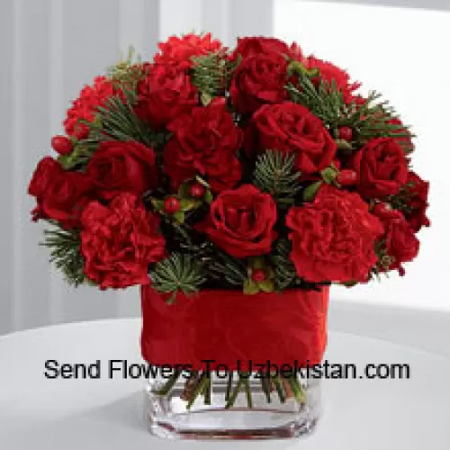 This Bouquet is a cheerful expression of all the merry moments this holiday season has to offer. Bright red spray roses, red mini carnations, burgundy mini carnations, red hypericum berries and assorted holiday greens are elegantly arranged in a clear glass vase bedecked with a rich red ribbon to create a holiday greeting in the spirit of this wondrous season of giving and gratitude. (Please Note That We Reserve The Right To Substitute Any Product With A Suitable Product Of Equal Value In Case Of Non-Availability Of A Certain Product)