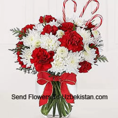 Sweeten their Christmas with a bounty of blooms and festive candy canes! A darling bouquet of red carnations and white chrysanthemums are accented with peppermint candy canes for a holiday presentation that is sure to make their holiday warm and bright. A memorable way to be a part of their holiday festivities! (Please Note That We Reserve The Right To Substitute Any Product With A Suitable Product Of Equal Value In Case Of Non-Availability Of A Certain Product)